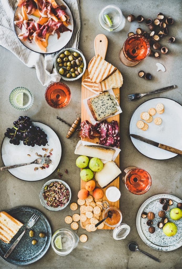 Mid summer seasonal picnic with rose wine, cheese, charcuterie and fruits